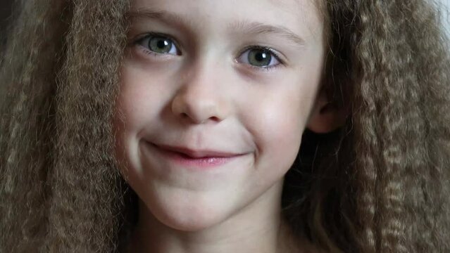 Cute little girl smiles and shows her fallen front milk teeth. Teeth growth. Close-up. Portrait of a 6-year-old rebec