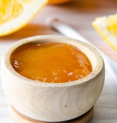 Orange jam served in spoon on the table