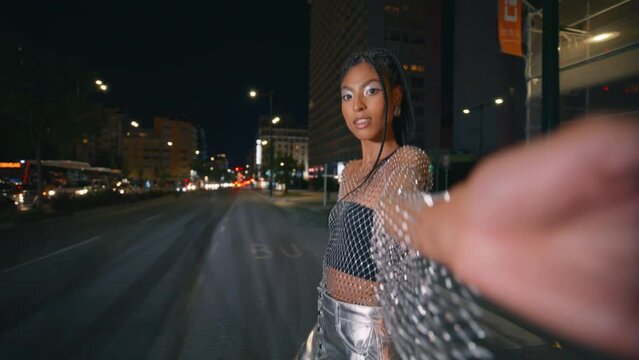 Dark skin model walking night city closeup. Afro braids woman looking camera
