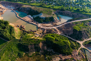 Aerial view of a flooded sand quarry with working sand dredgers