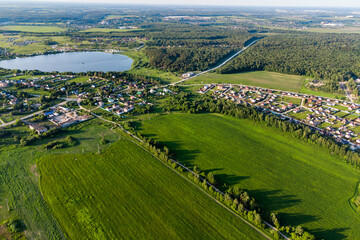Aerial landscape with a view of the countryside with green fields and village houses