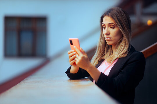 Puzzled Businesswoman reading a Text Message on her Smartphone. Skeptical person reading misinformation and online fake news 
