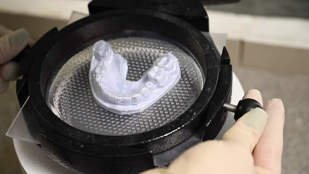 Mouth guard for teeth, printed on a 3D printer in dental clinic laboratory. 4k cinematic slow motion video