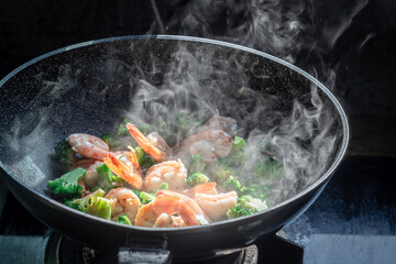 Stir the vegetables in the pan ,Cooking stir fry Shrimp with broccoli in pan