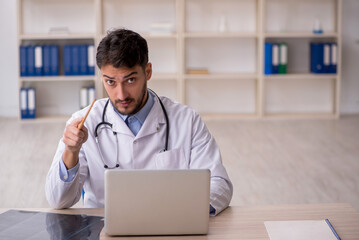 Young male doctor in telemedicine concept