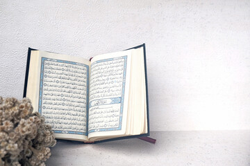 Opened Quran with Flowers Background