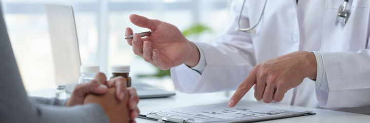 Medical service worker or doctor, pharmacist talking about medical test results at table in clinic...