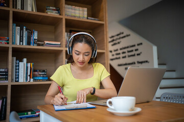 Young woman having video call via computer in the home office.Business video conferencing.