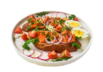 toast with smoked salmon, onion and vegetables on a white plate close up