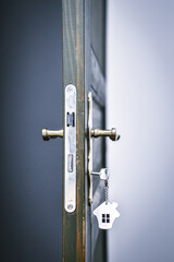 door handle and key in the keyhole with house pendant. Ideal photo for real estate and financial...