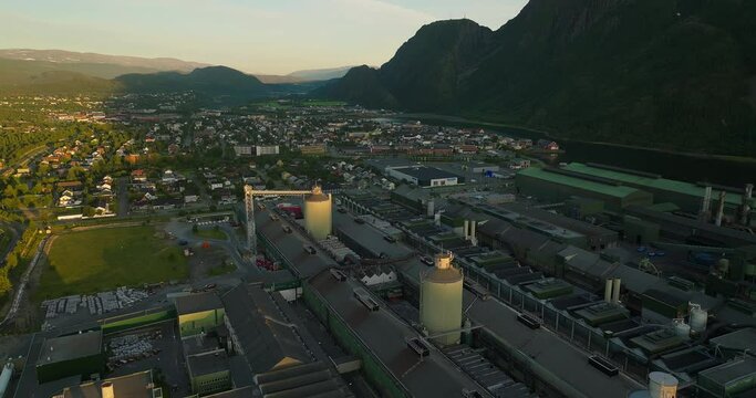 Aerial in midnight sun over Mosjøen aluminium manufacturing plant, Vefsn, Norway