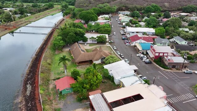 Aerial Kauai Hawaii Hanapepe Swinging Bridge. Hanapepe River flows to Pacific Ocean through historical town. Swinging suspension bridge sways as you cross it. Historically plantation style buildings.