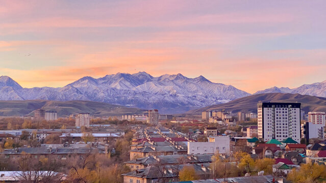 Fototapeta Amazing dawn view from the window of the slightly snowy Kyrgyz mountains. Ala Archa National Reserve, view from afar. Autumn in the capital of Kyrgyzstan - Bishkek.