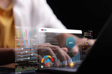 Data analyst working on business analytics dashboard with charts, with KPI and metrics connected to...