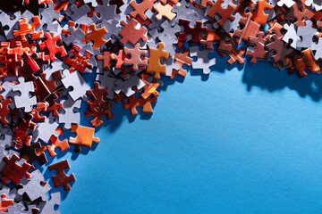 Mixed Peaces of a Colorful Jigsaw Puzzle Lie on the Blue Background With Copy Space - Strategy and...