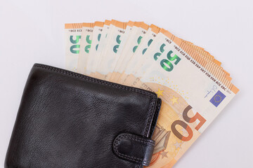 Black Leather Men Wallet with Fifty Euro Banknotes Inside - on White Background. A Purse Full of Money Symbolizing Wealth, Success and Social Status - Isolation