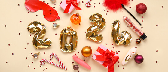 Figure 2024 made of balloons, sex toys and Christmas decorations on beige background