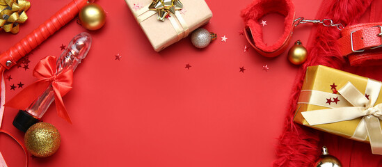 Sex toys, Christmas gifts and decorations on red background with space for text