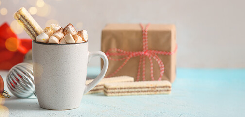 Cup of hot chocolate with marshmallows and Christmas decorations on table. Banner for design