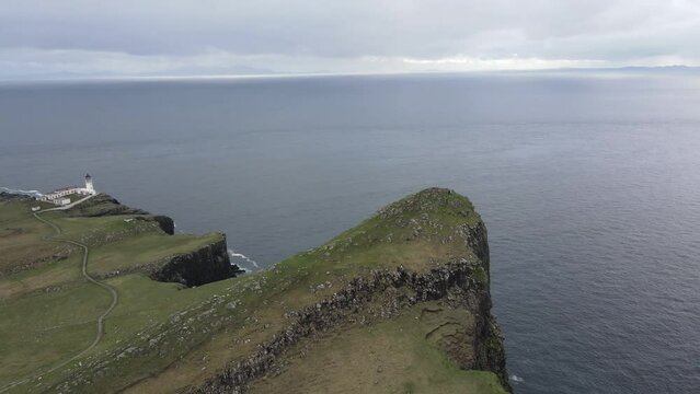 Aerial view of Neist Point encapsulating the untamed beauty of the Scottish coastline, where nature's forces have sculpted a rugged masterpiece that is both awe-inspiring and serene.