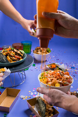 the hand holding mayonnaise bottle and rice blow in party and sharing concept