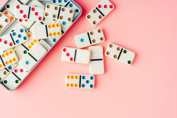 Domino tiles on pink background studio shot