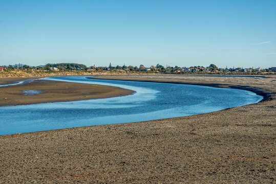 Mouth of the Waikanae river in New Zealand, with houses of Paraparaumu in the distance