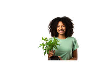 Female volunteer stands holding a plant and smiles at the camera. transparent background