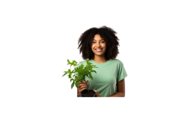 Female volunteer stands holding a plant and smiles at the camera. transparent background