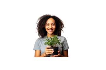 Female volunteer stands holding a plant and smiles at the camera. transparent background