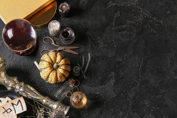 Witch's magic attributes with pumpkin on dark background
