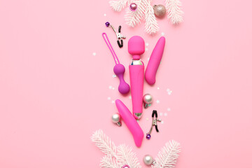 Sex toys and Christmas decor on pink background