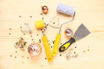 Composition with painter's supplies and Christmas decorations on wooden background