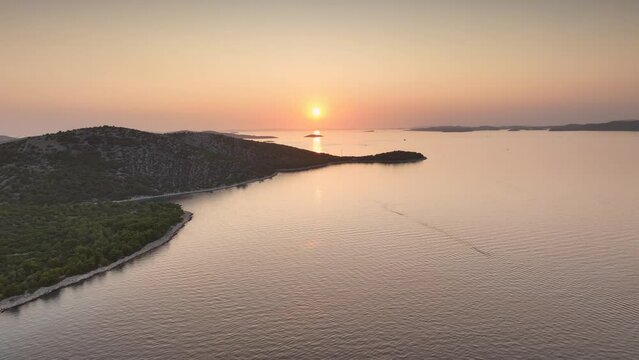 Colorful sunset over Kornati national park in Croatia on a summer day. Drone dolley shot