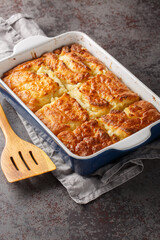 Butter swim biscuits are buttermilk biscuits baked in a pool of melted butter closeup on the table. Vertical
