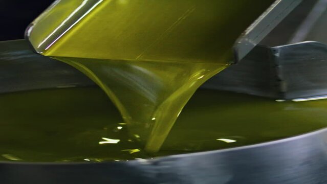 Olive oil production process at food manufactory vertical view close up. 