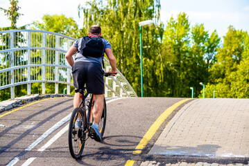 Naklejka premium Cyclist ride on the bike path in the city Park 