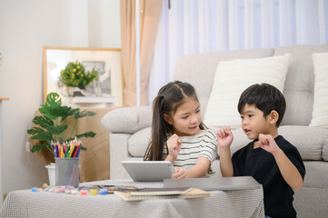 Asian girls and boys enjoy fun educational and learning holiday activities and have fun using...