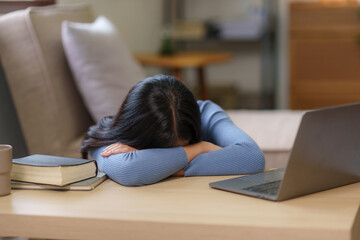 Young Asian woman suffering from stress sit alone at home, dejected. Desperate Asian woman feeling...