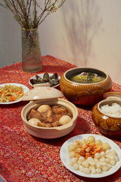 Amazing of Vietnamese food for Tet holiday in spring, it is traditional food on lunar new year: pork belly with hard-boiled eggs braised in coconut water, mixed pickles, rice