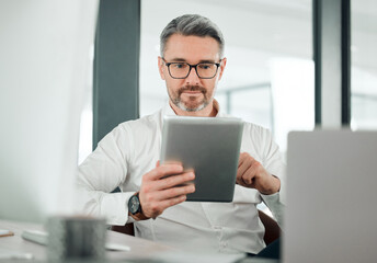 Mature man, business and tablet at desk in office for planning research, online report or scroll...