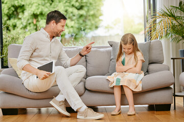 Parent, child and tablet with discipline on a sofa in the living room for naughty behavior at home....