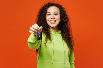 Young smiling woman of African American ethnicity wears green hoody casual clothes hold car keys...