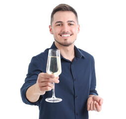 Young man with glass of champagne on white background. New Year celebration