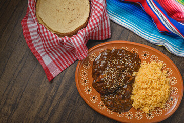 Mole, typical Mexican food. Traditional Mexican dish served in a clay dish.