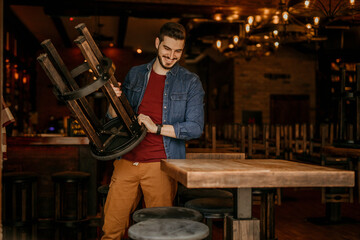 The restaurant owner starts the day early, wiping down tables and setting the scene for a fresh dining experience