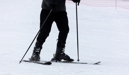 Men ski on snow in winter
