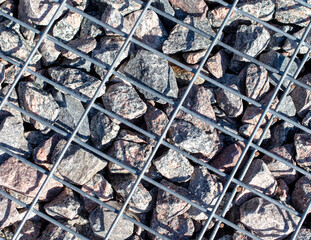 Stones under a metal grate. Background