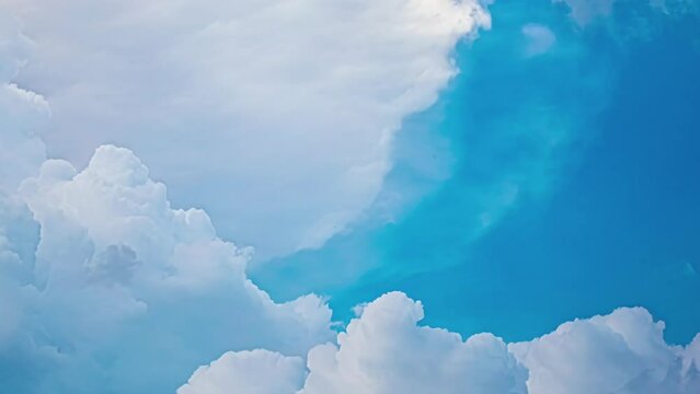 White clouds in motion in a turquoise blue sky. Timelapse of clouds in the sky.