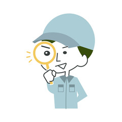 虫眼鏡で何かを診断する作業員の男性